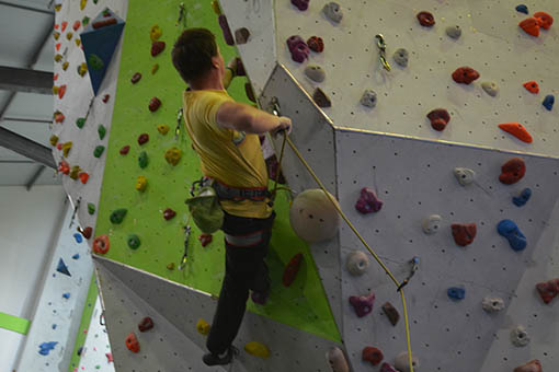 A large image of a climber climbing through an overhanging roof