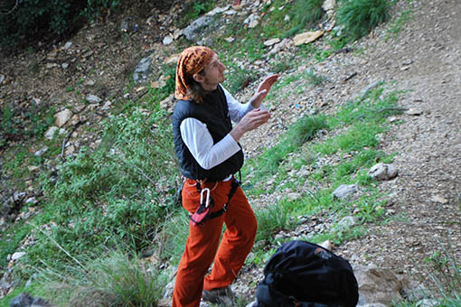 A small image of a climber studying a climb