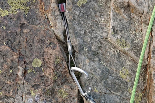 A small image of a climbing nut placed into a crack