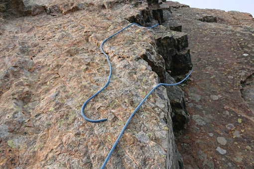 A large image of a rope stuck half way up a cliff