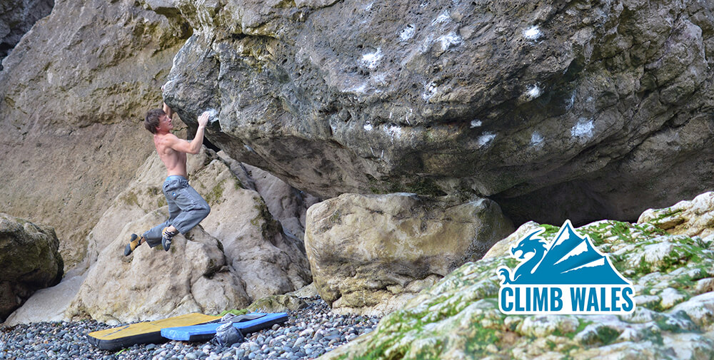 A strong climber bouldering down at the Angel Bay boulders