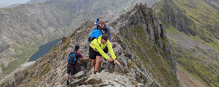 Traversing the ridge of Crib Goch, the pinnacles visible in the background