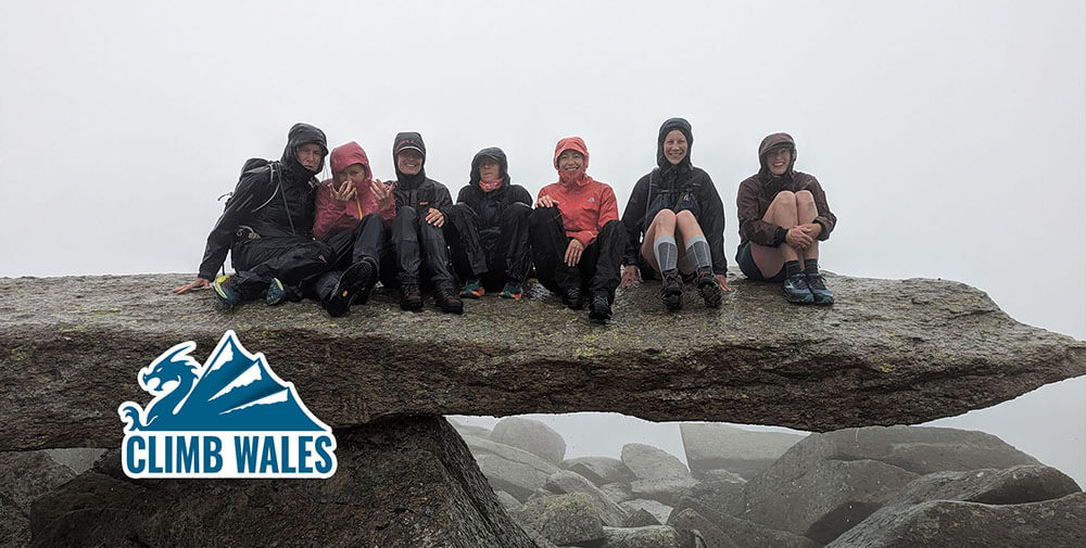 7 Ladies sat atop the Cantilever Stone on Glyder Fach in the pouring rain.